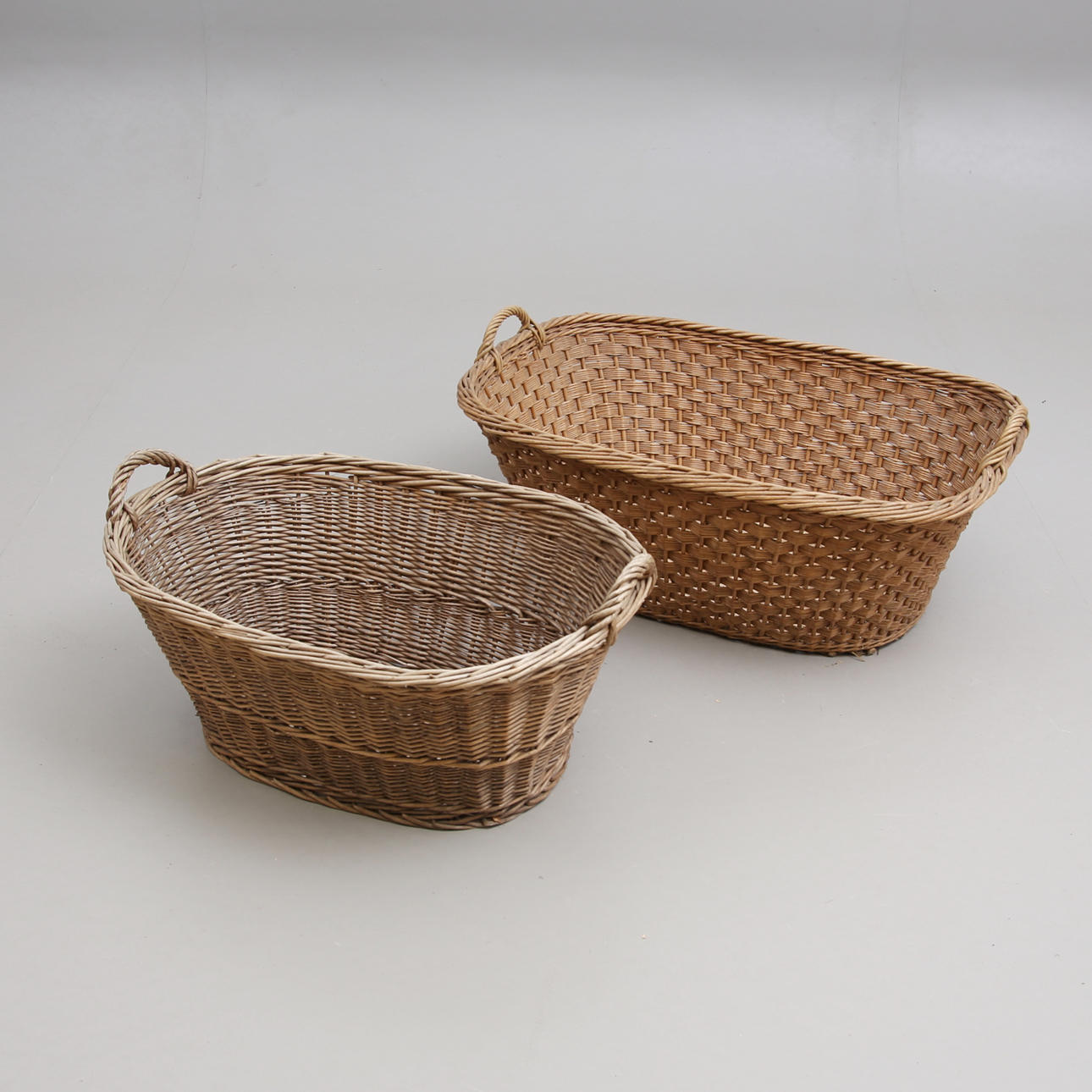A set of two 20th century laundry baskets.