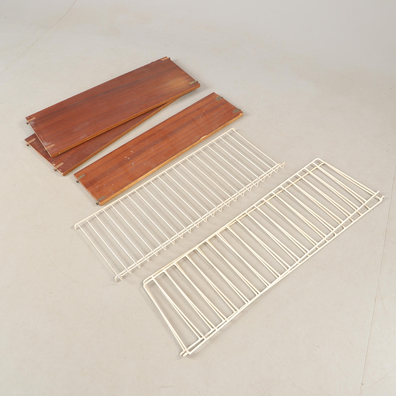 A mid 20th century mahogany wall shelf with a String model.