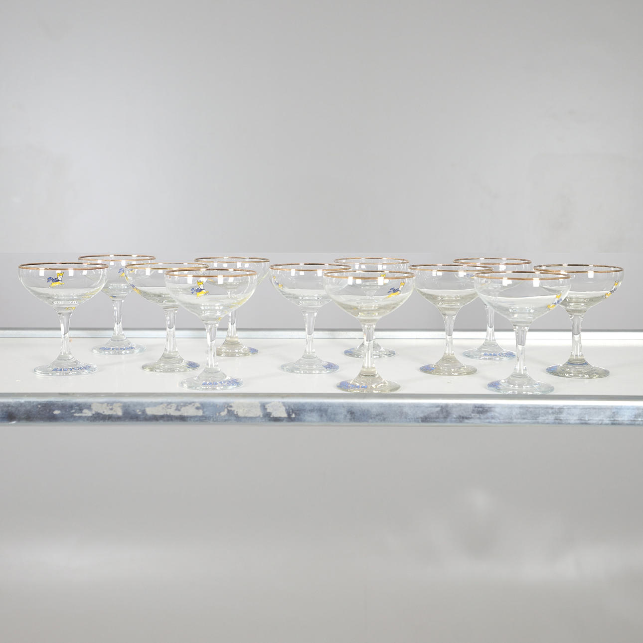 TWELVE BABYCHAM COUPE GLASSES WITH LOGO.
