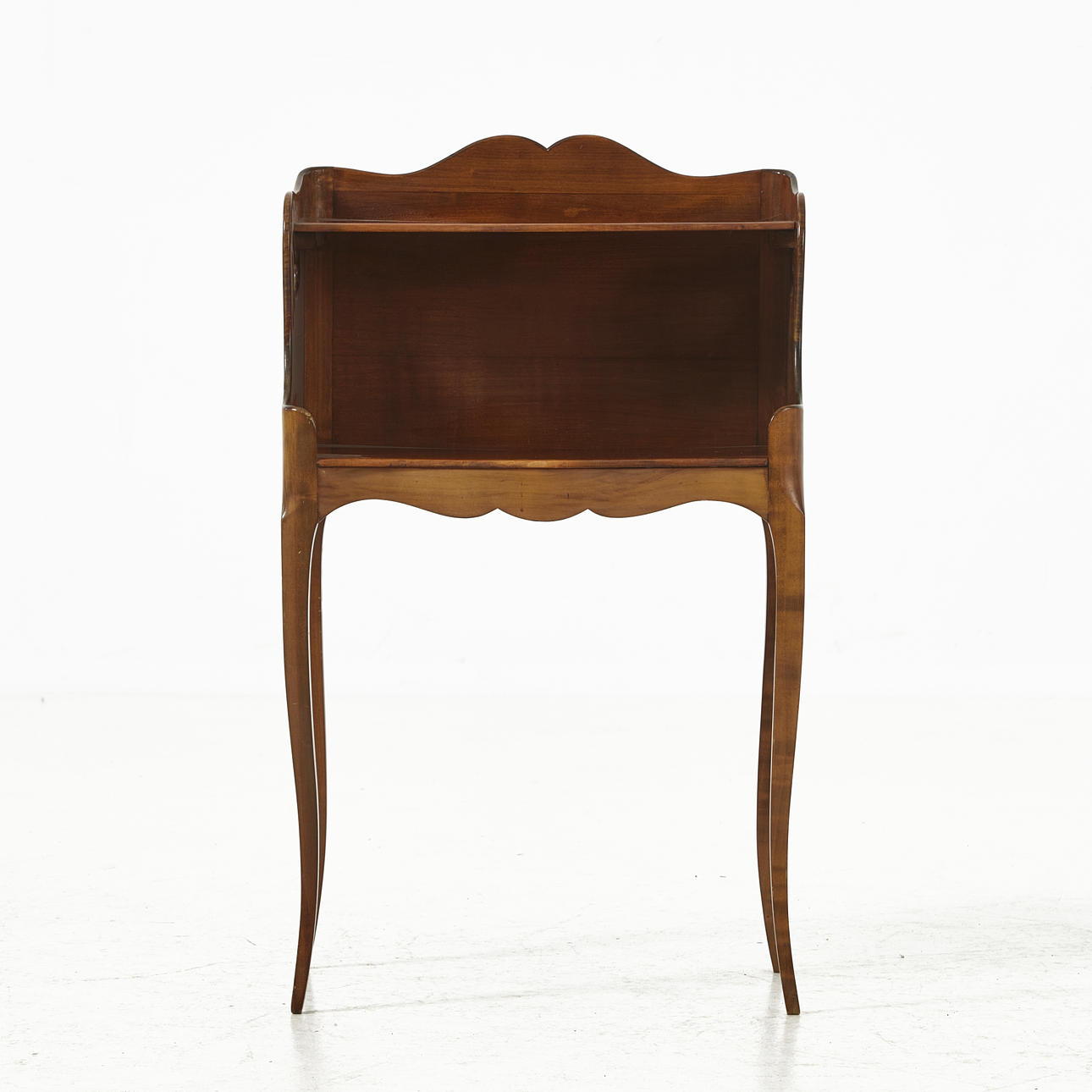 A 20th century bedside table, dark stained, rococo style.