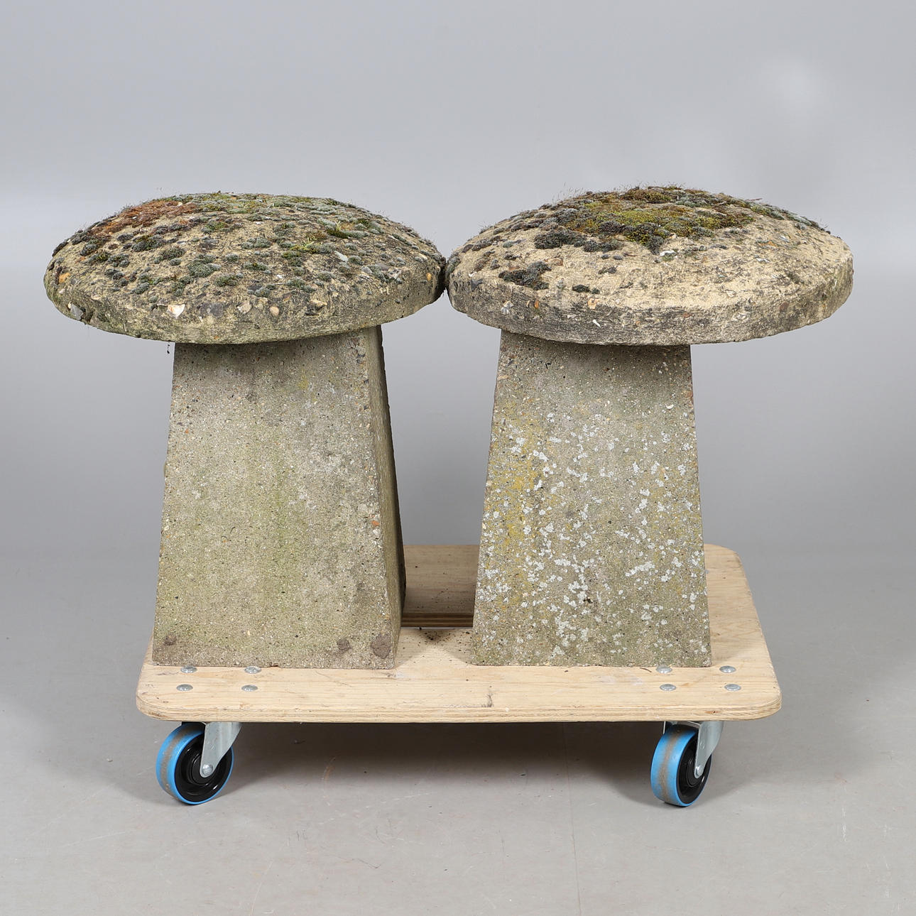 TWO CONCRETE STADDLE STONES.