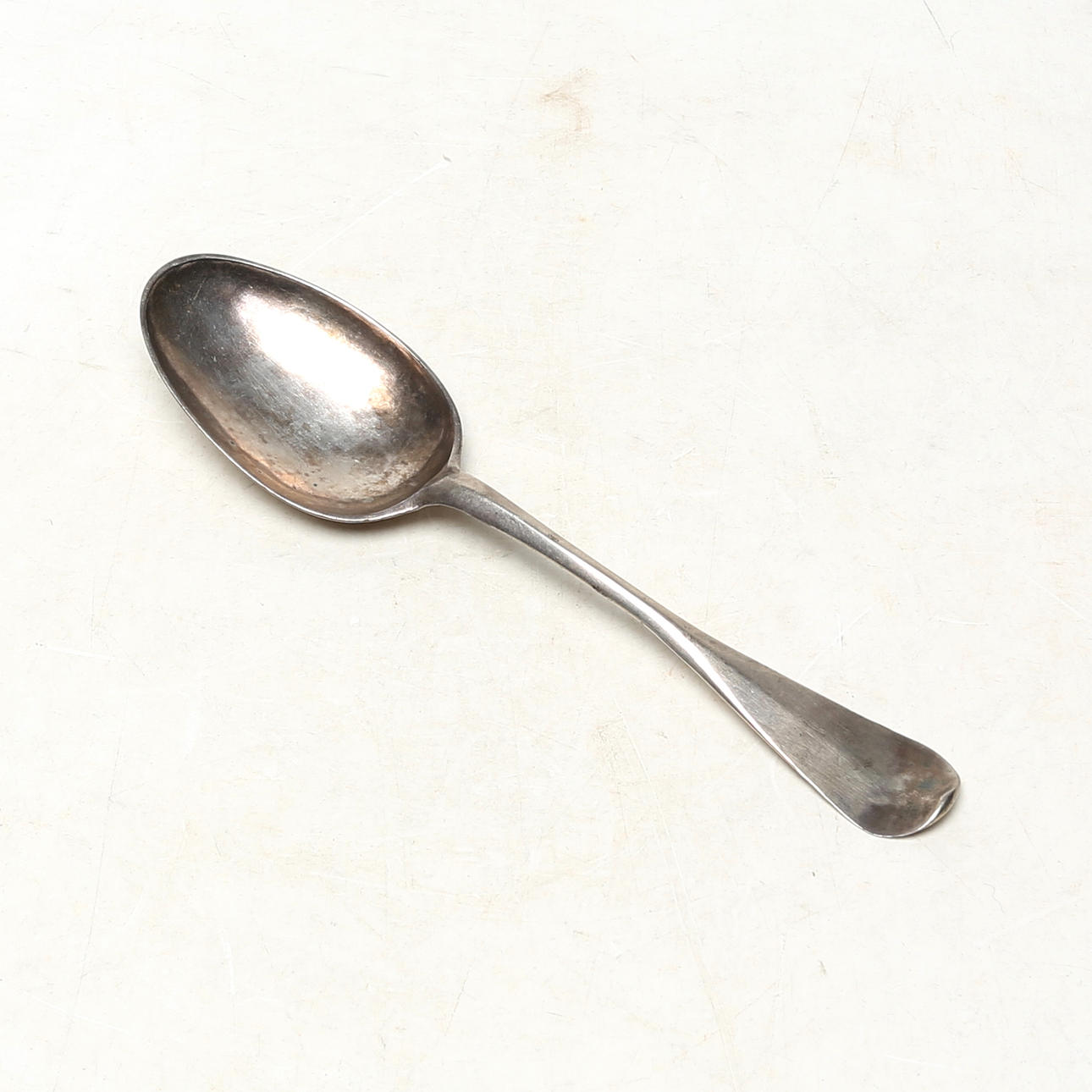 A silver spoon, old man's vine, antique.