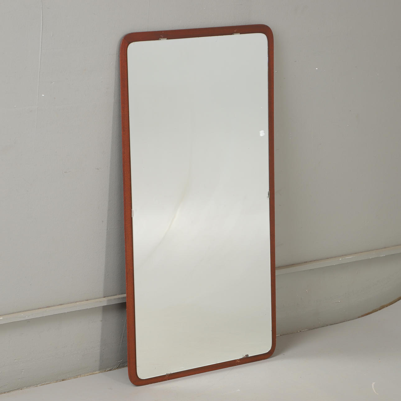 A mid 20th century teak mirror.