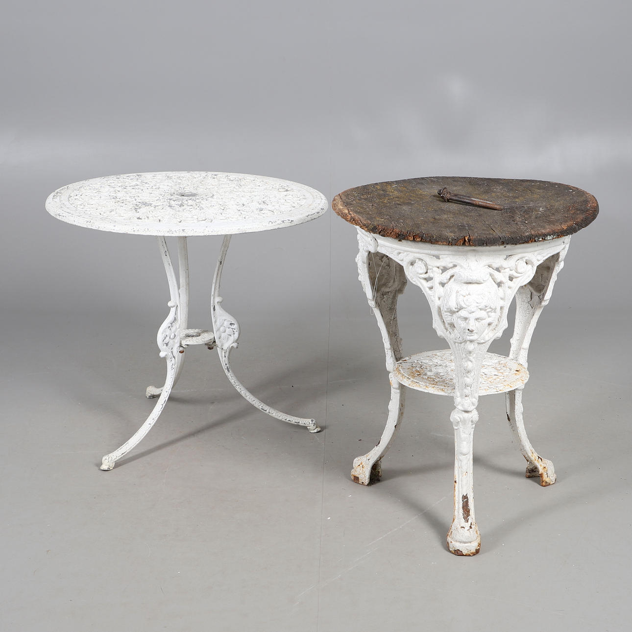 TWO PAINTED CAST IRON GARDEN TABLES.