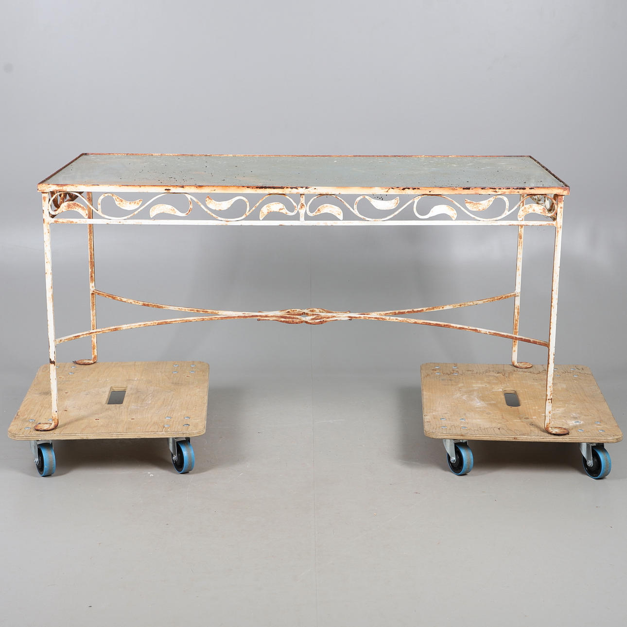 A WHITE PAINTED GLASS TOPPED IRON TABLE.