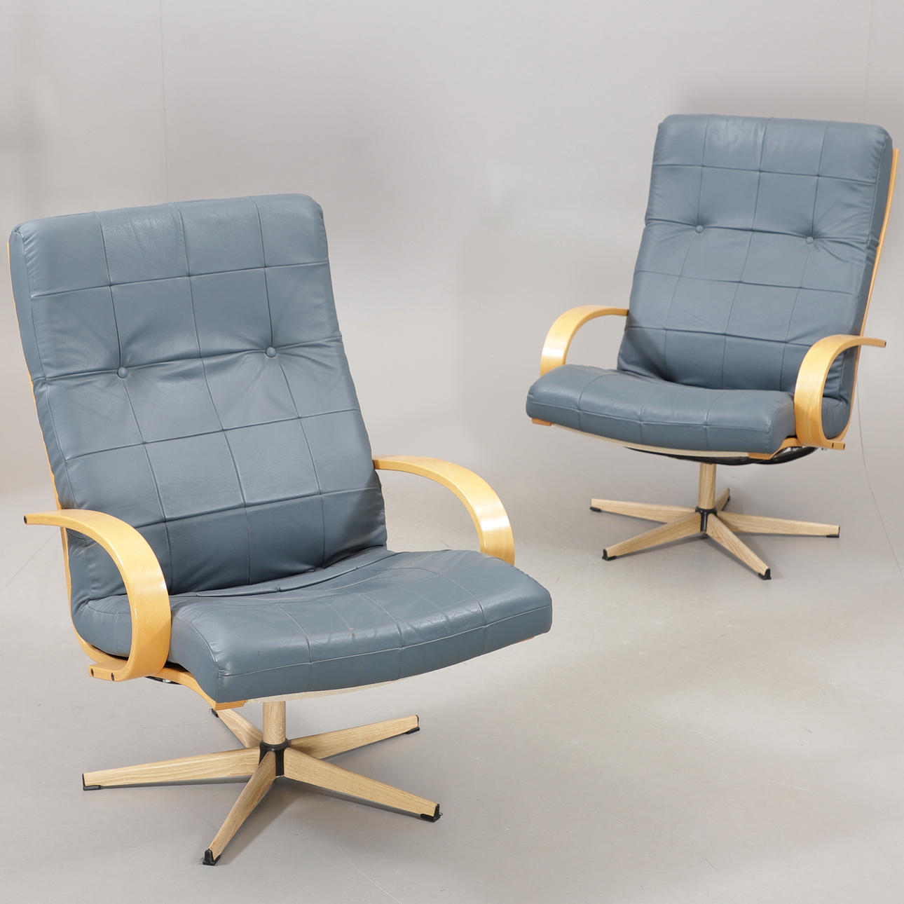 SPINNING ARMCHAIRS, a pair, leather/beech, 1900/2000s.