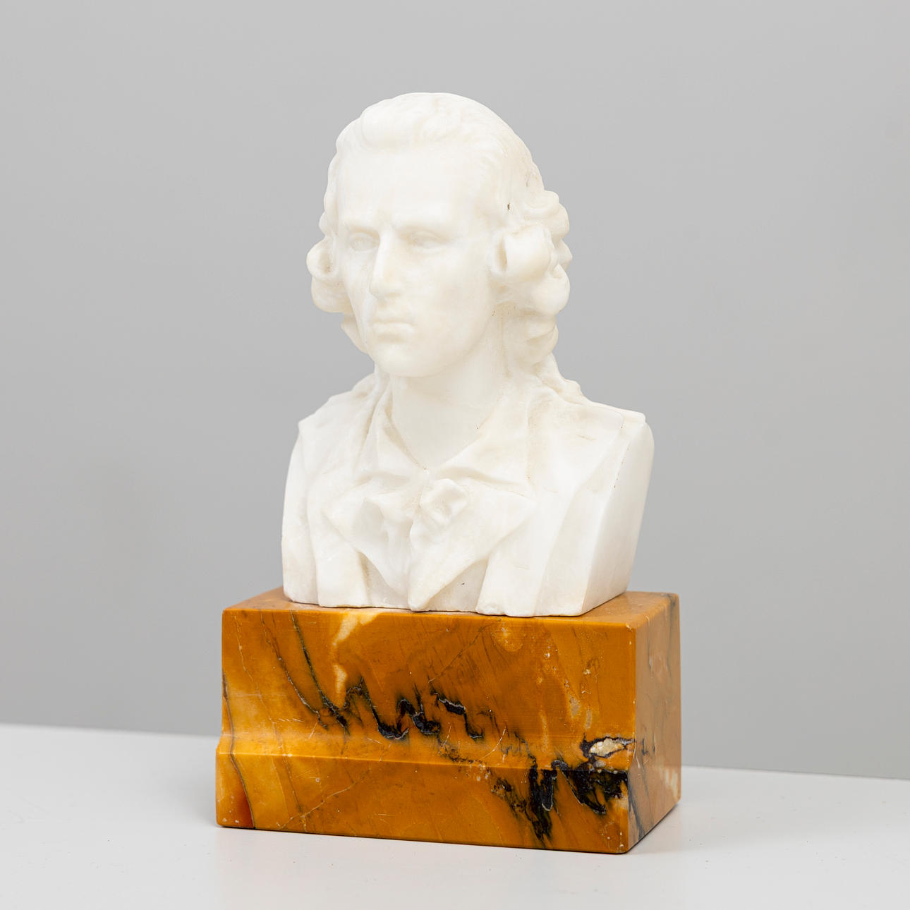 BUST, white stone on plinth, 20th century.