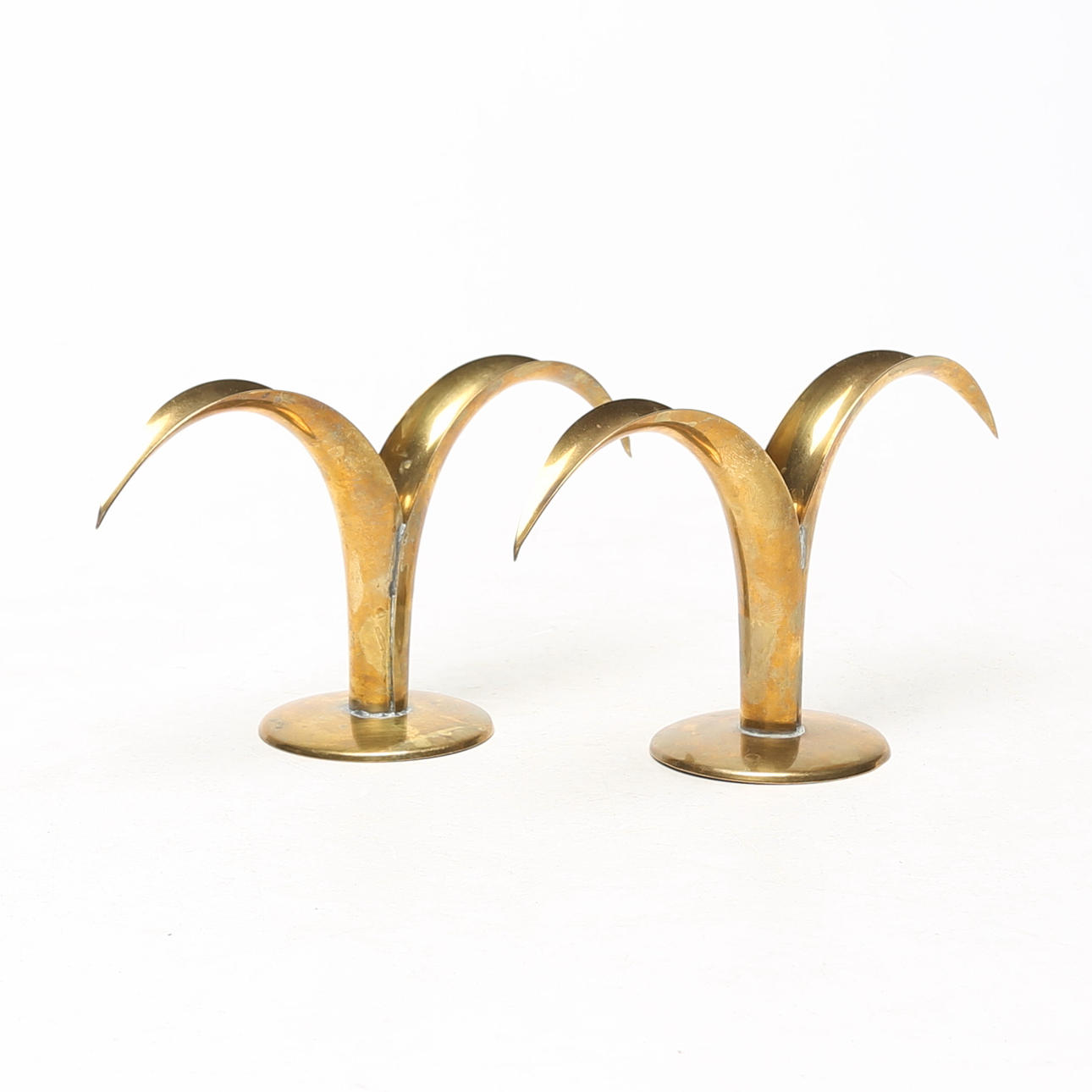 A pair of brass candlesticks, unsigned.