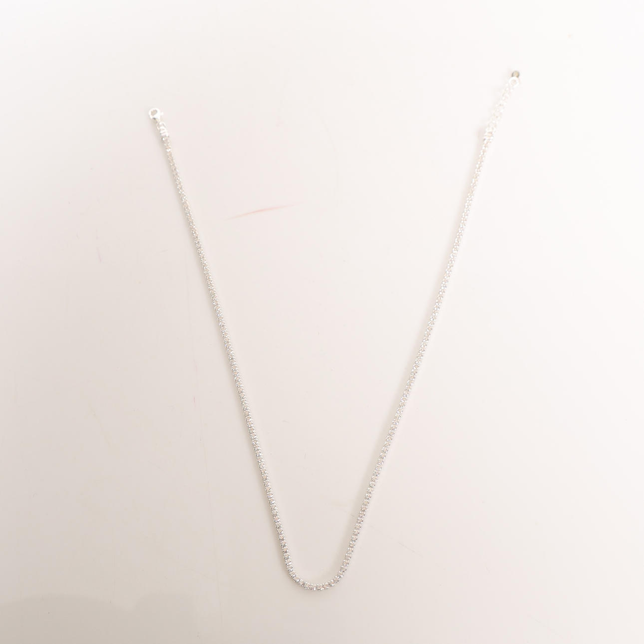 A SILVER AND MOISSANITE NECKLACE.
