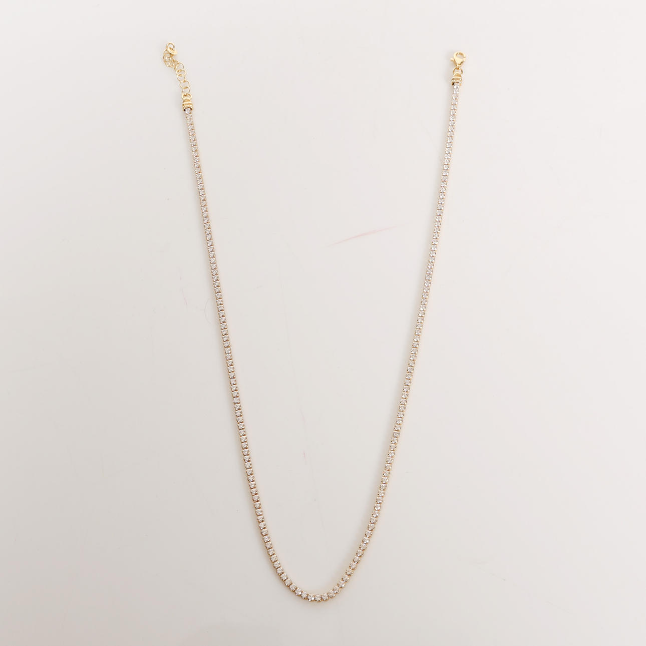 A SILVER GILT MOISSANITE NECKLACE.