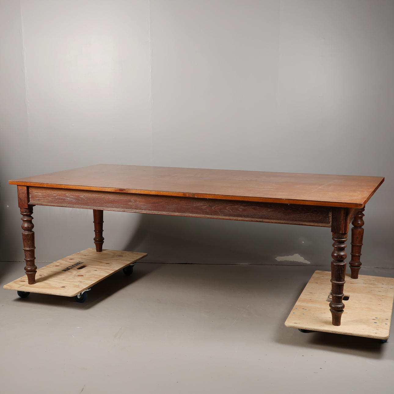A LARGE OAK DINING TABLE WITH LATER TOP.