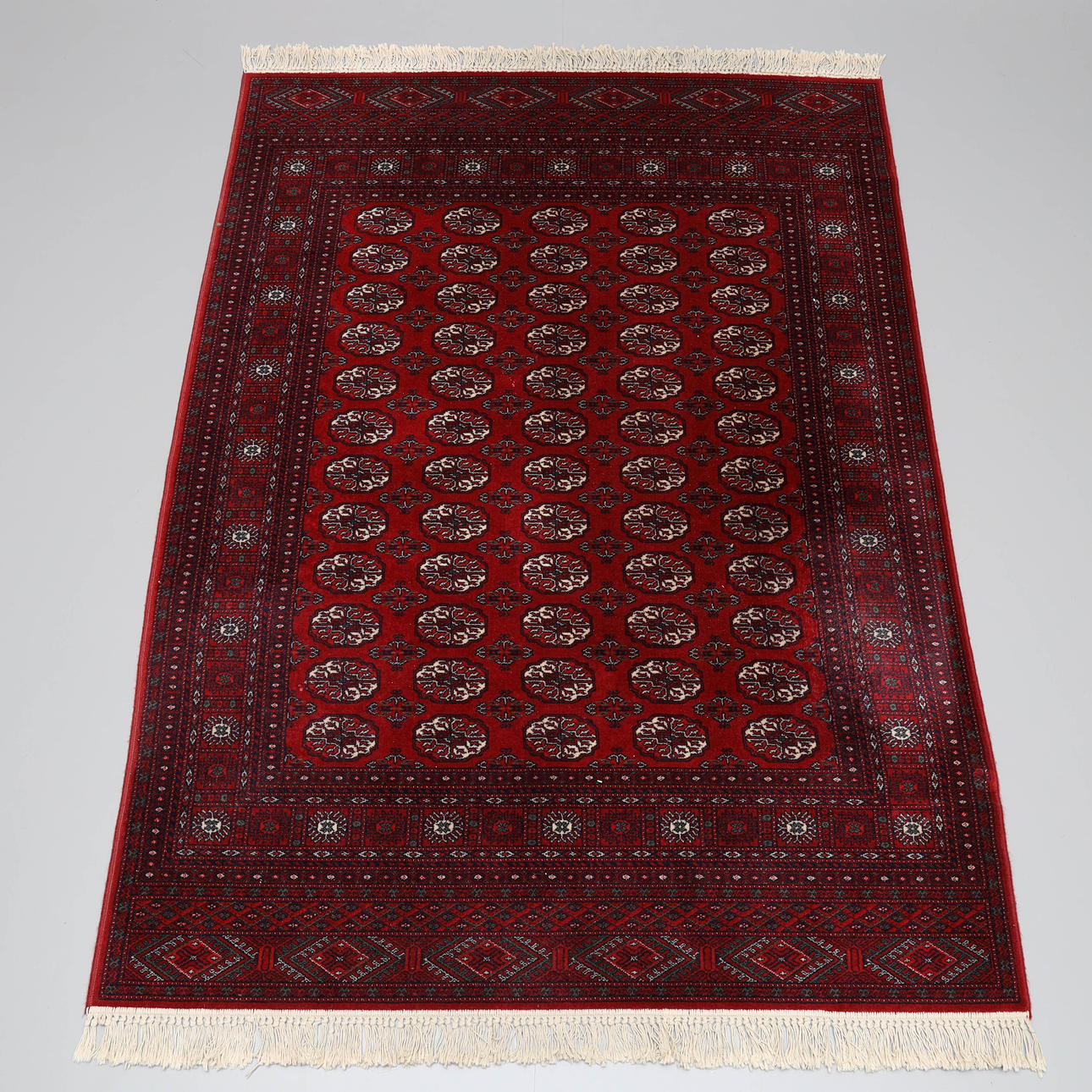 A carpet, machine-knotted, oriental style.