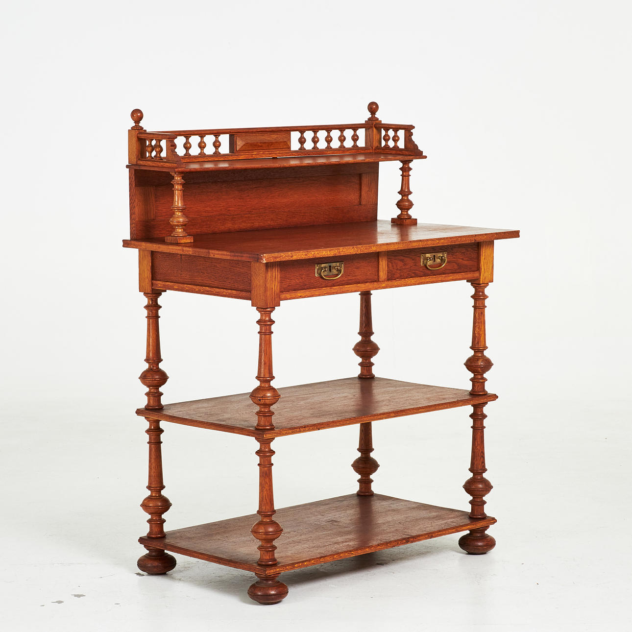 SERVING TABLE, with essay, Neo-Renaissance style, stained oak, two pull-out drawers, bottom with shelves, fittings in yellow metal, 20th century.