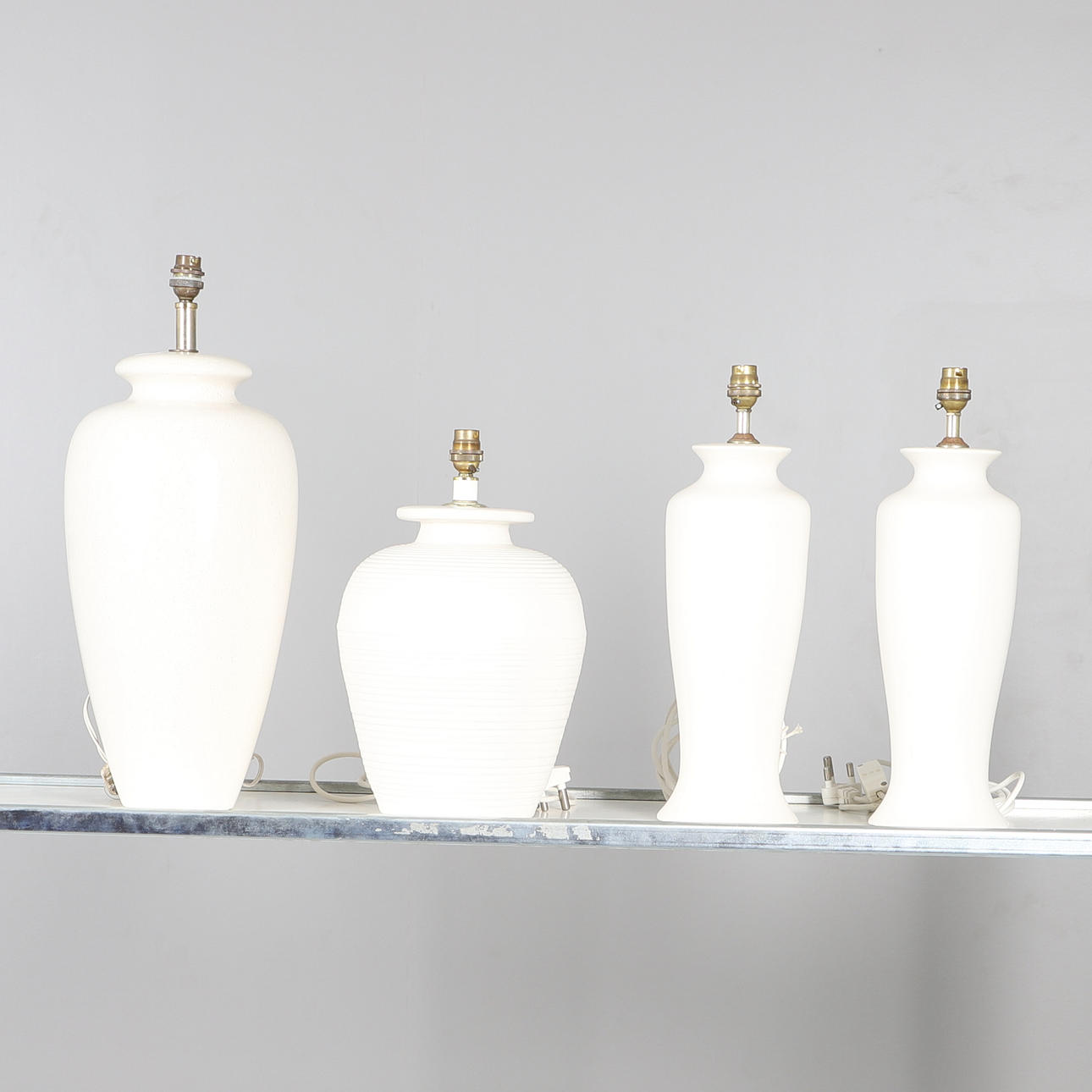 FOUR CREAM POTTERY TABLE LAMP BASES.