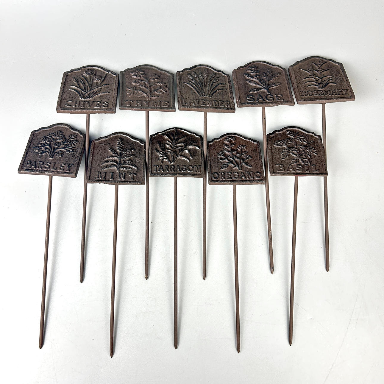 TEN CAST IRON HERB SIGNS.