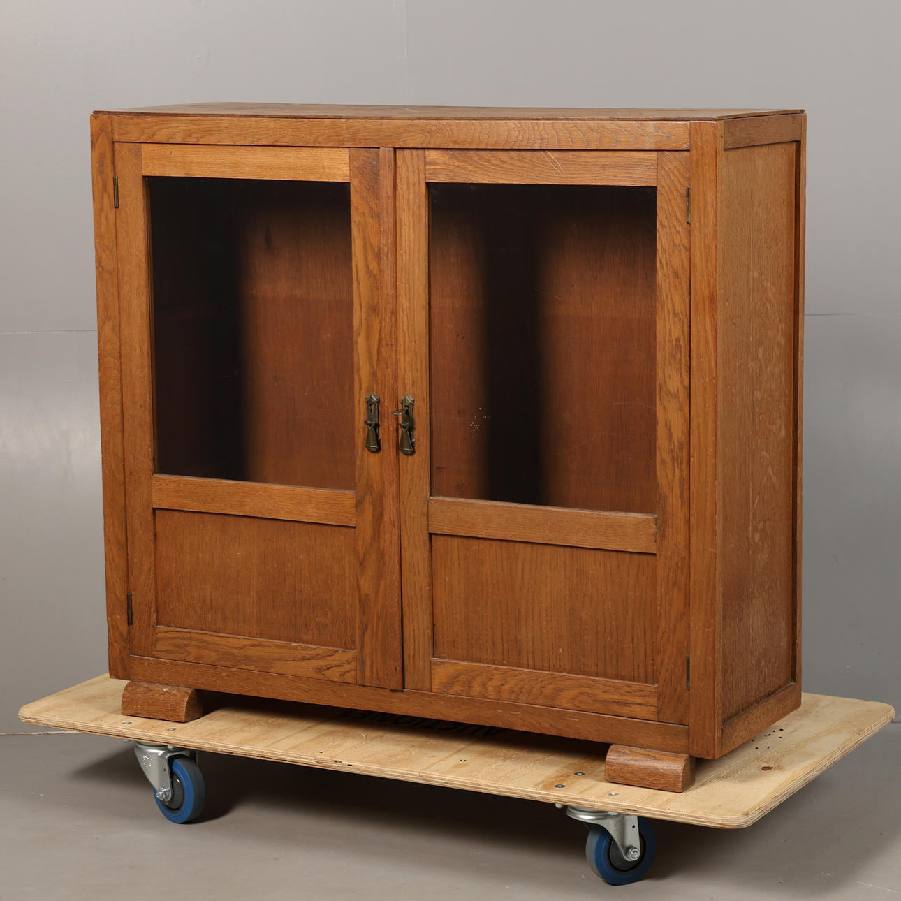 AN ART DECO OAK GLAZED BOOKCASE.