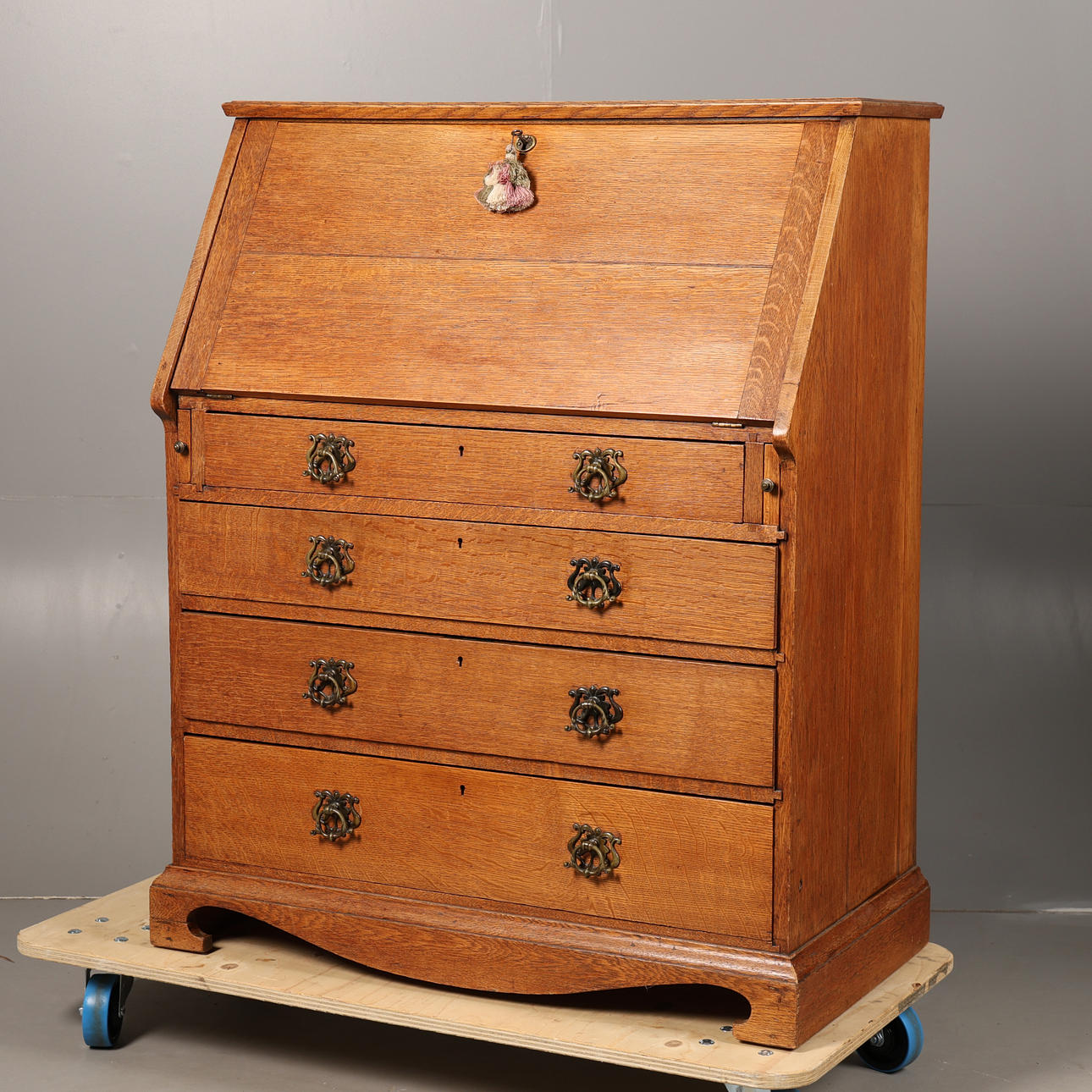 A 20TH-CENTURY OAK BUREAU.