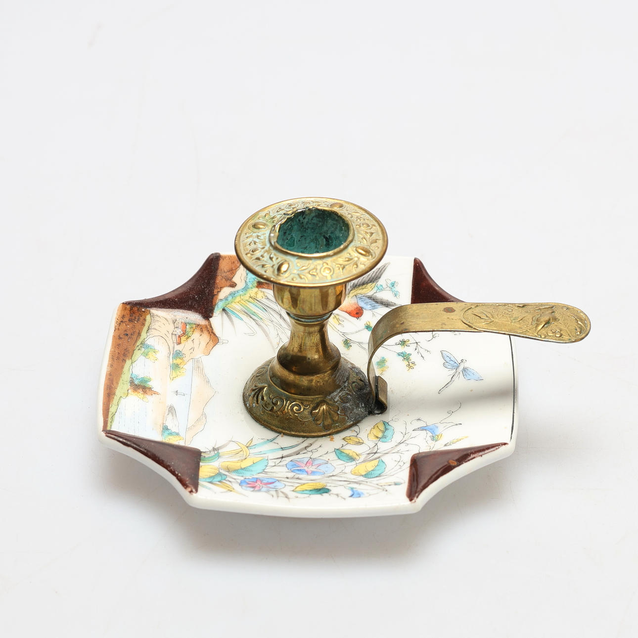 A brass candlestick, porcelain base, 20th century.