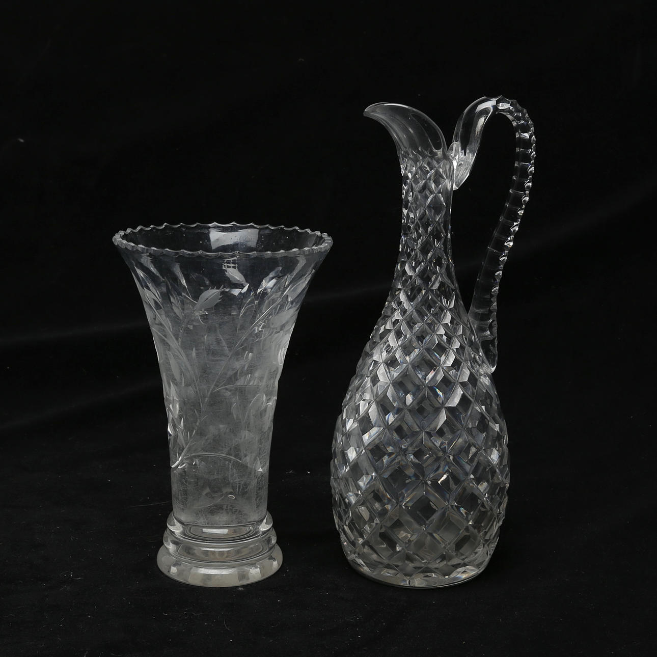 A glass decanter and vase.