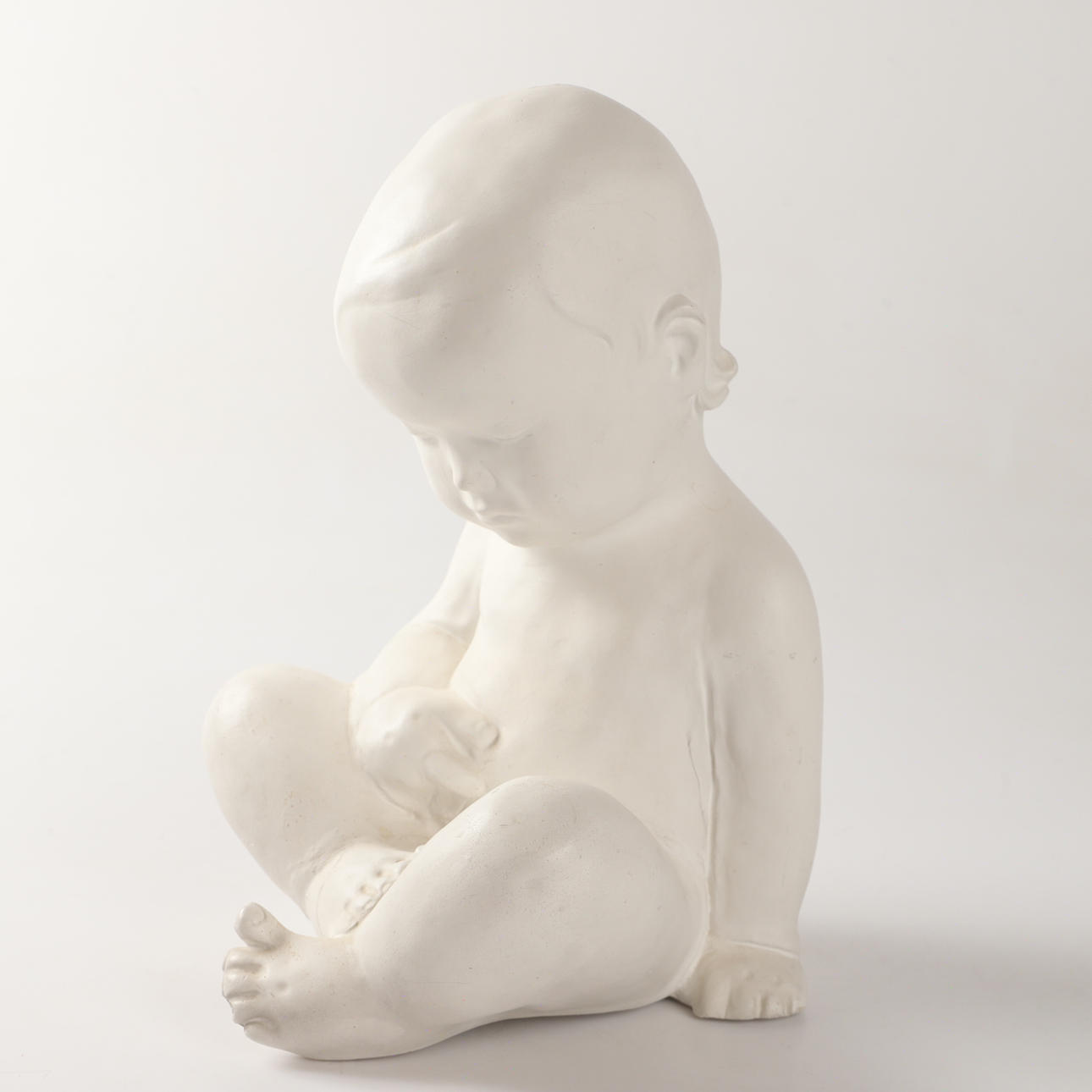 SCULPTURE, sitting child, painted plaster, indistinctly signed.
