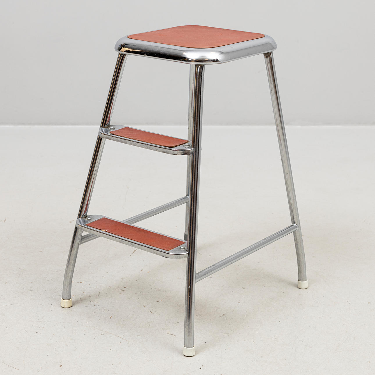 A metal step stool, AWAB, 20th century.
