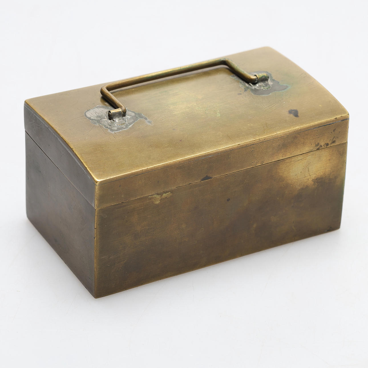 A brass box, mixed denomination coins, mostly Swedish.