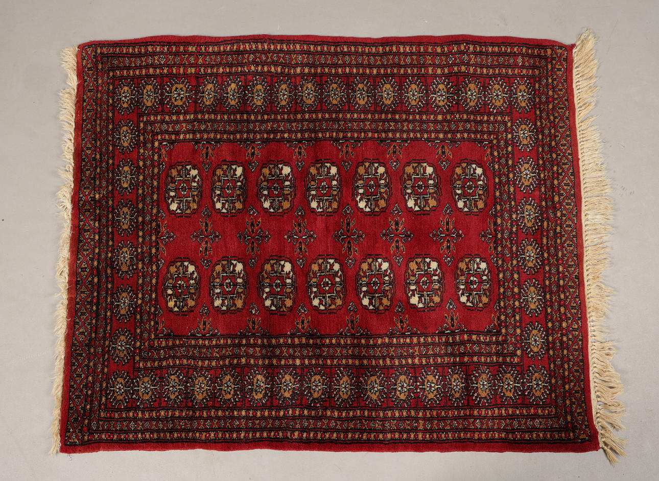 A BOKHARA WOOL RUG.