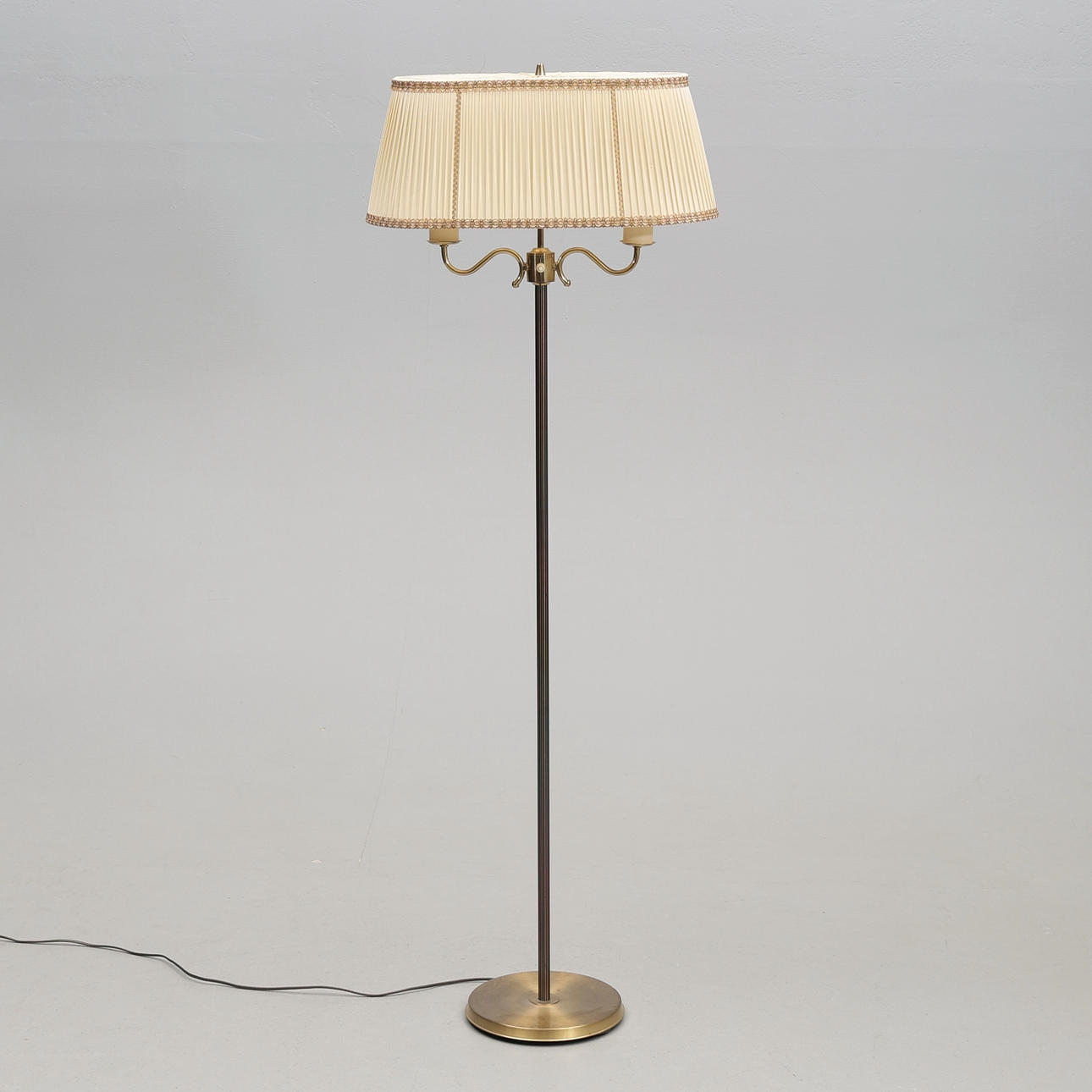 A brass floor lamp, mid 20th century.