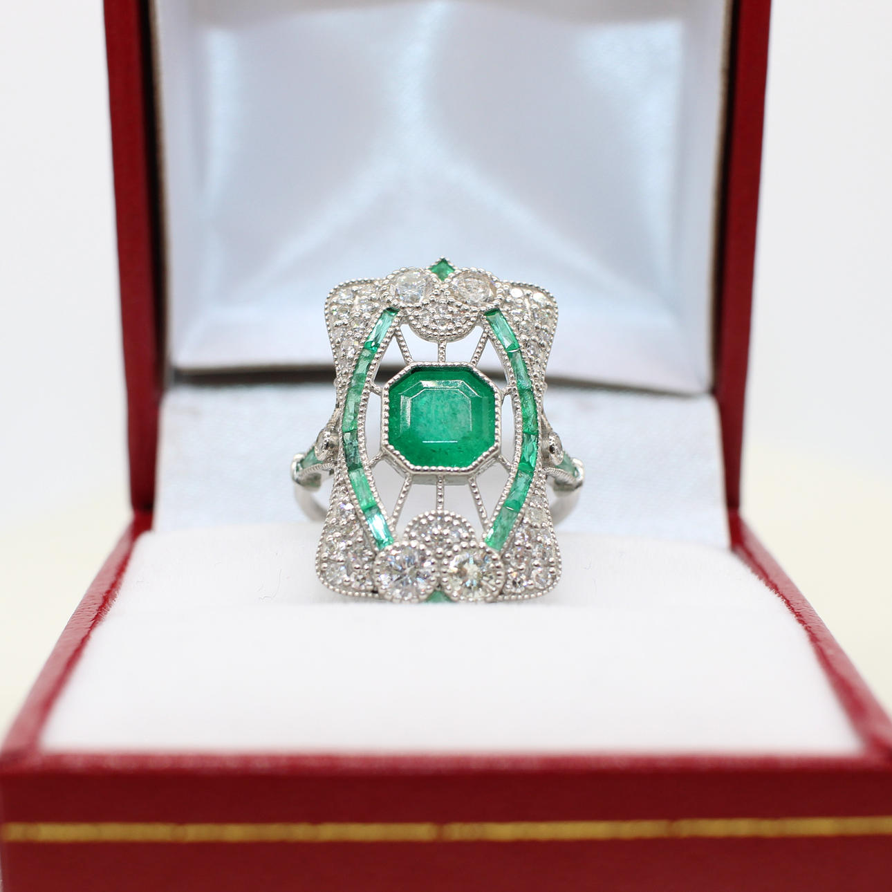 PLATINUM & EMERALD PANEL RING.