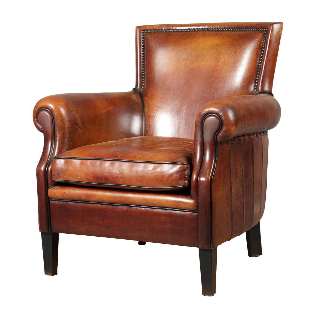 A BROWN LEATHER ARMCHAIR.