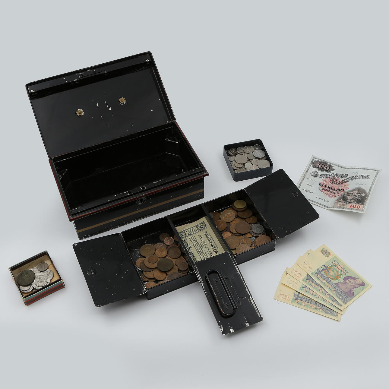 BANKNOTES AND COINS IN TIN BOXES.