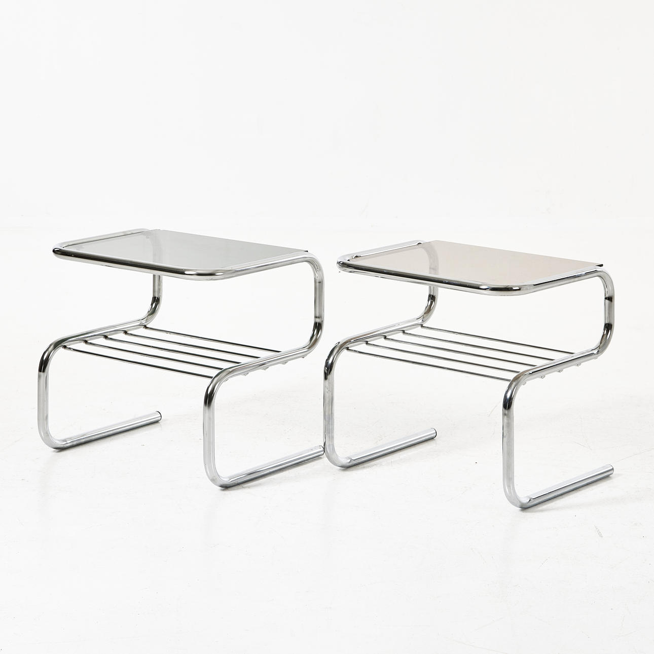 BRUNO MATHSSON. Bedside table, “Ulla”, chrome frame, different tinted glass tops, Dux, 1970s.