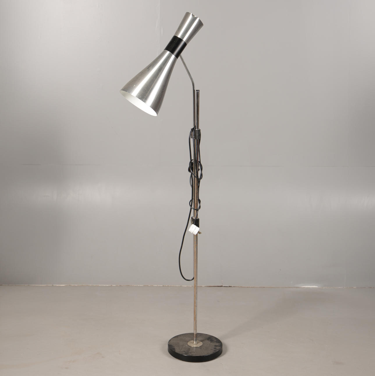 AN ADJUSTABLE ALUMINIUM READING LAMP.