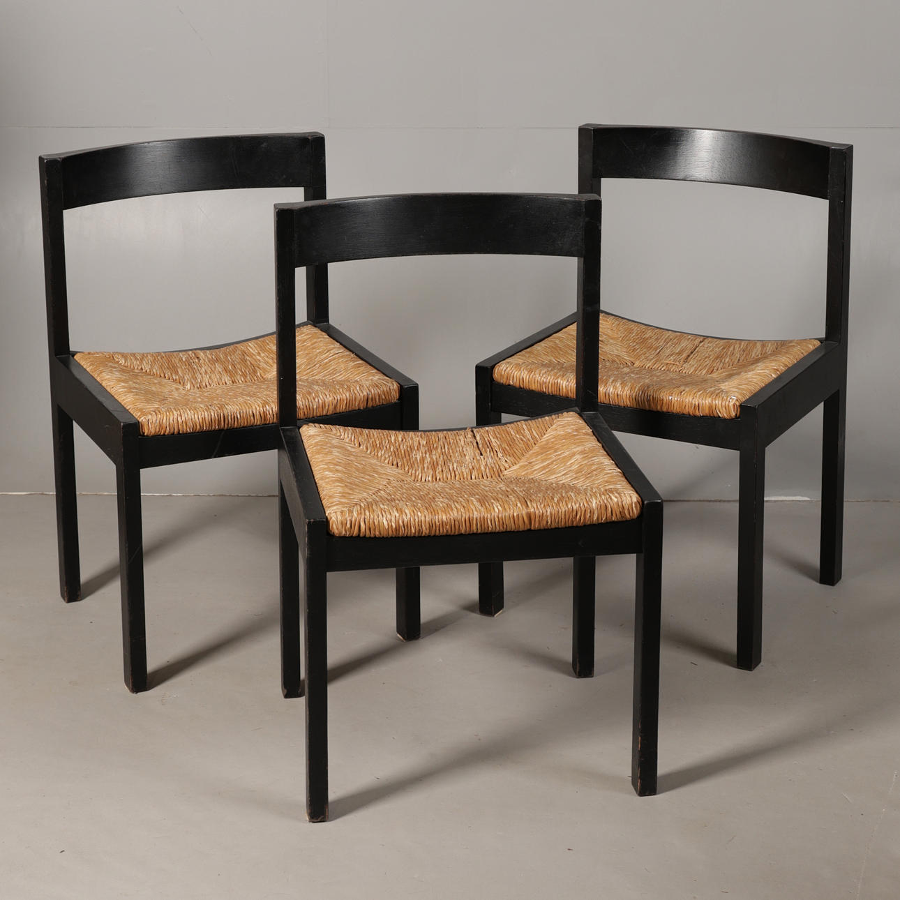 THREE 20TH-CENTURY EBONISED AND RUSH-SEATED CHAIRS (3).