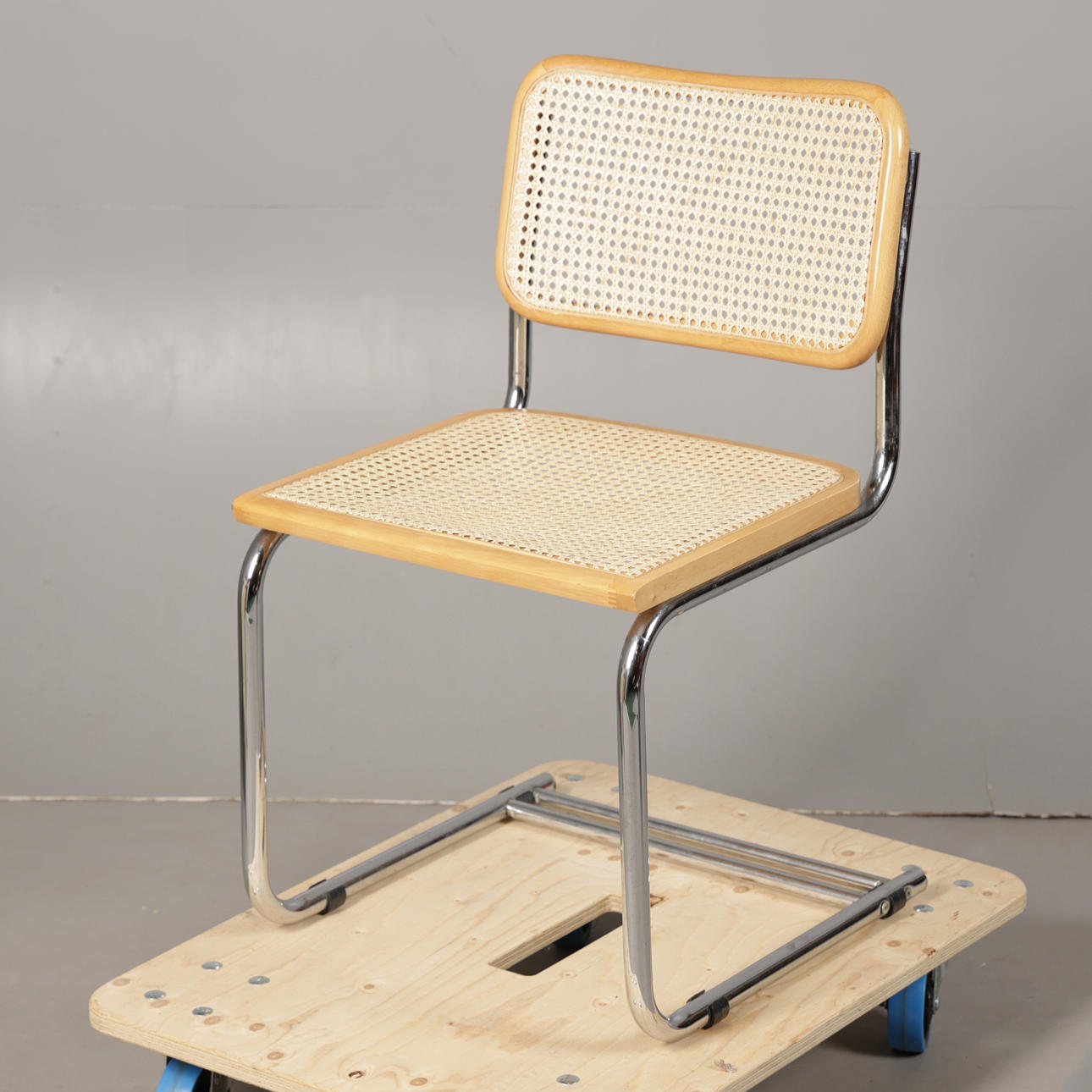 A CANE SEATED CANTILEVER CHAIR.
