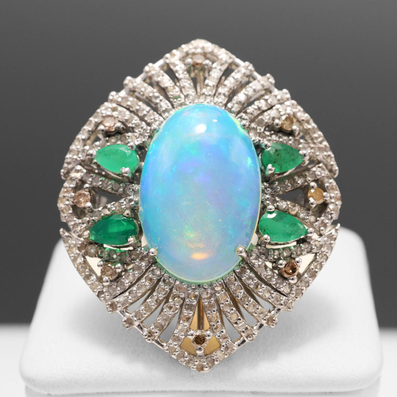 AN OPAL, EMERALD AND DIAMOND DRESS RING.