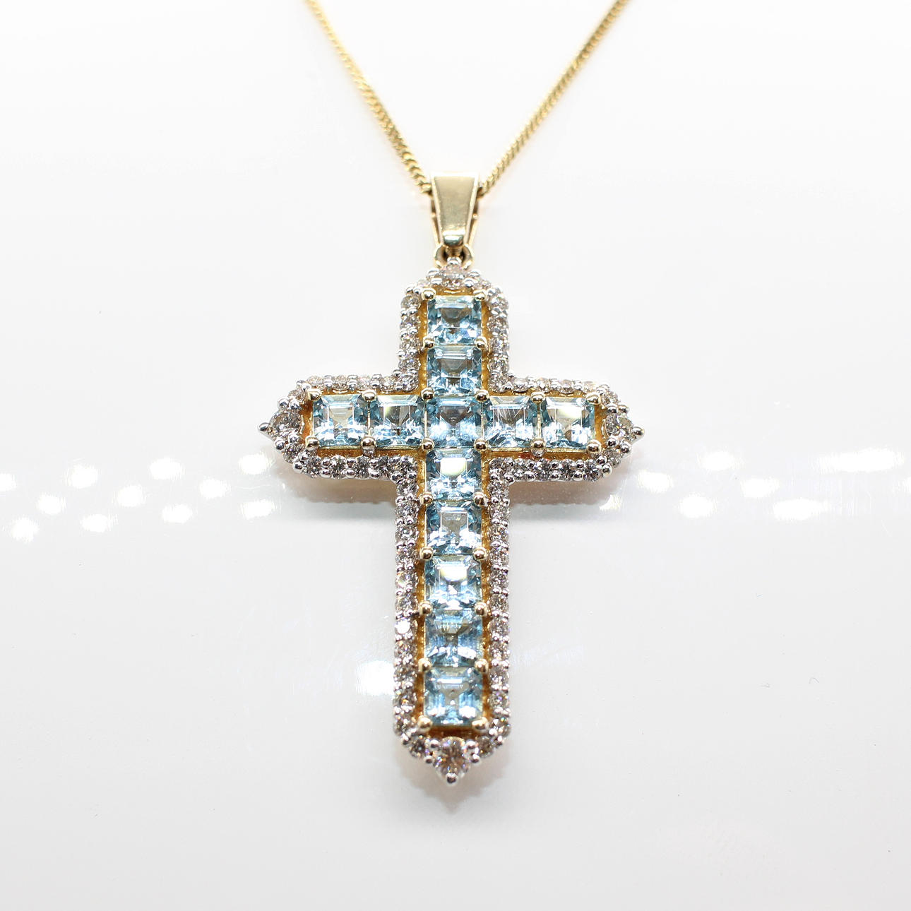 AQUAMARINE & DIAMOND CROSS NECKLACE.