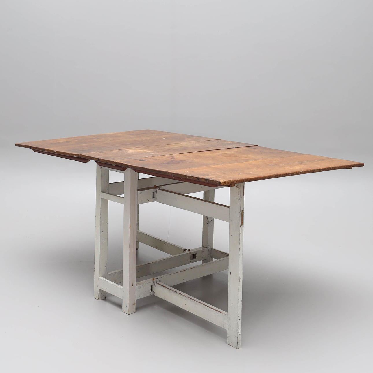 A stained fir table with painted base, 19th century.