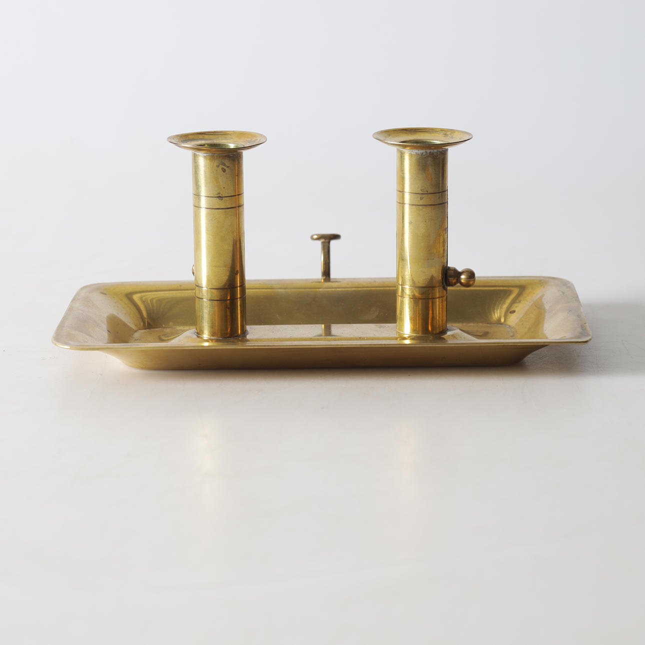 A brass candlestick for two candles, 20th century.