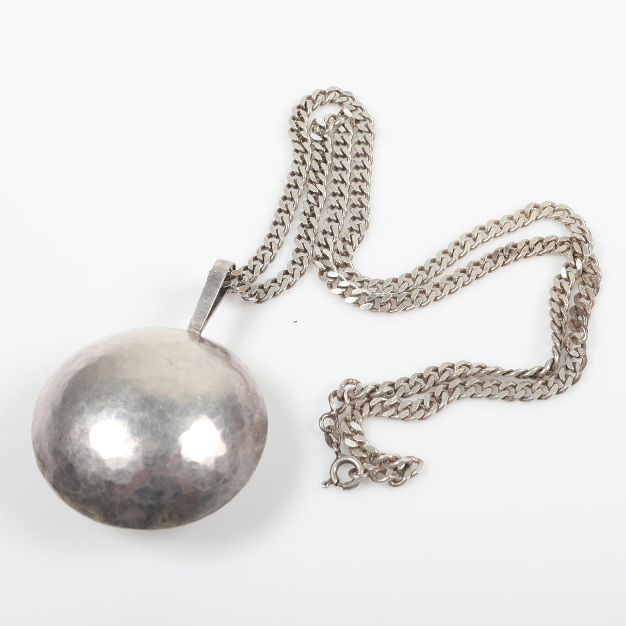 PENDANT WITH CHAIN, silver with hammered decoration.