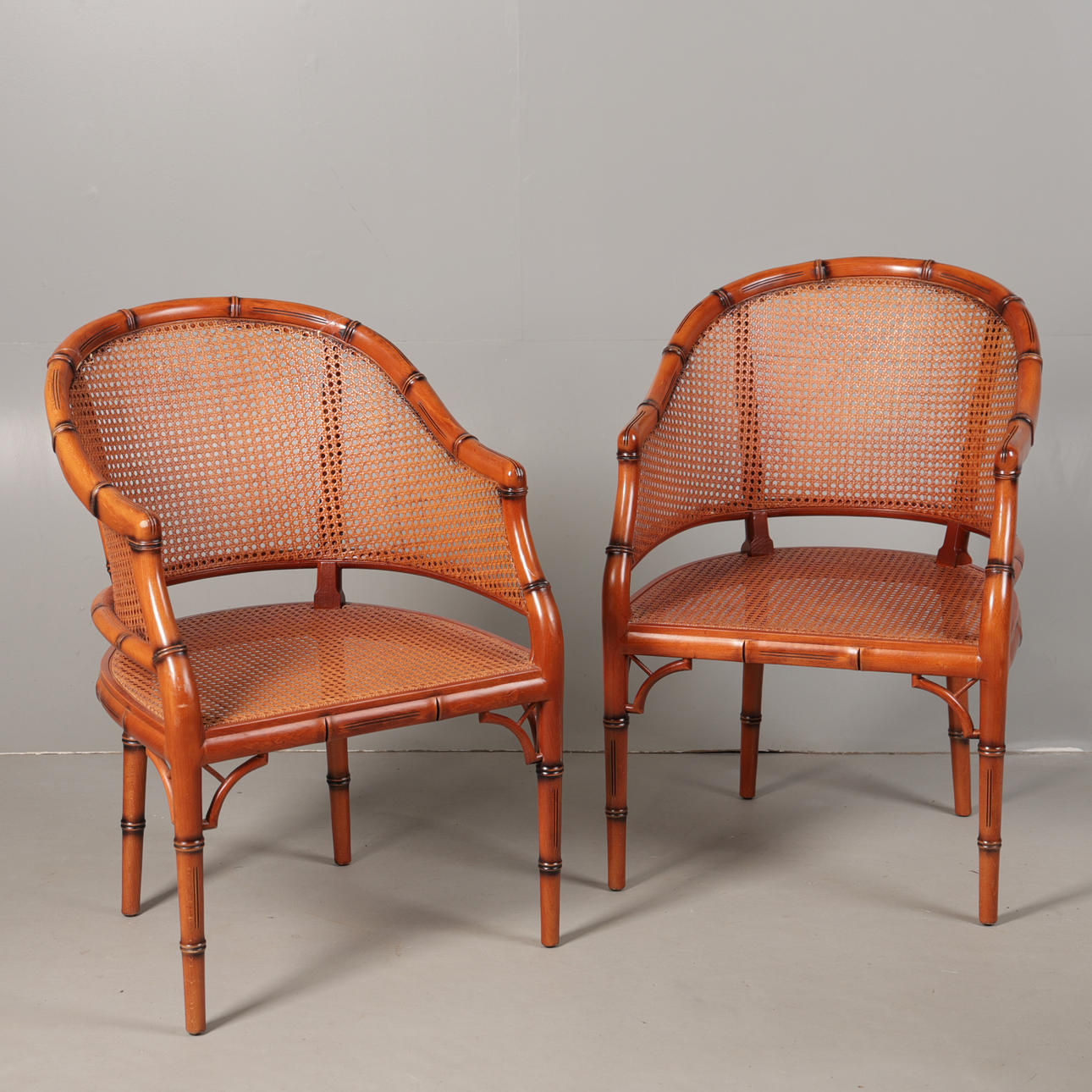 A PAIR OF CANE ARMCHAIRS (2).