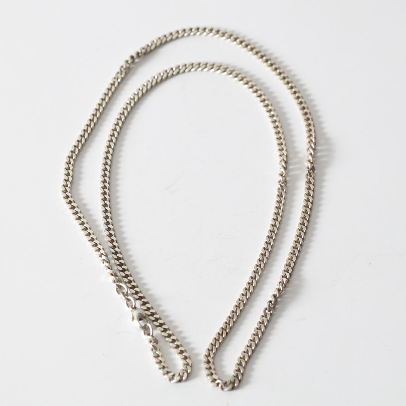 A sterling silver armour-link necklace. Total weight approx. 25.2 grams.