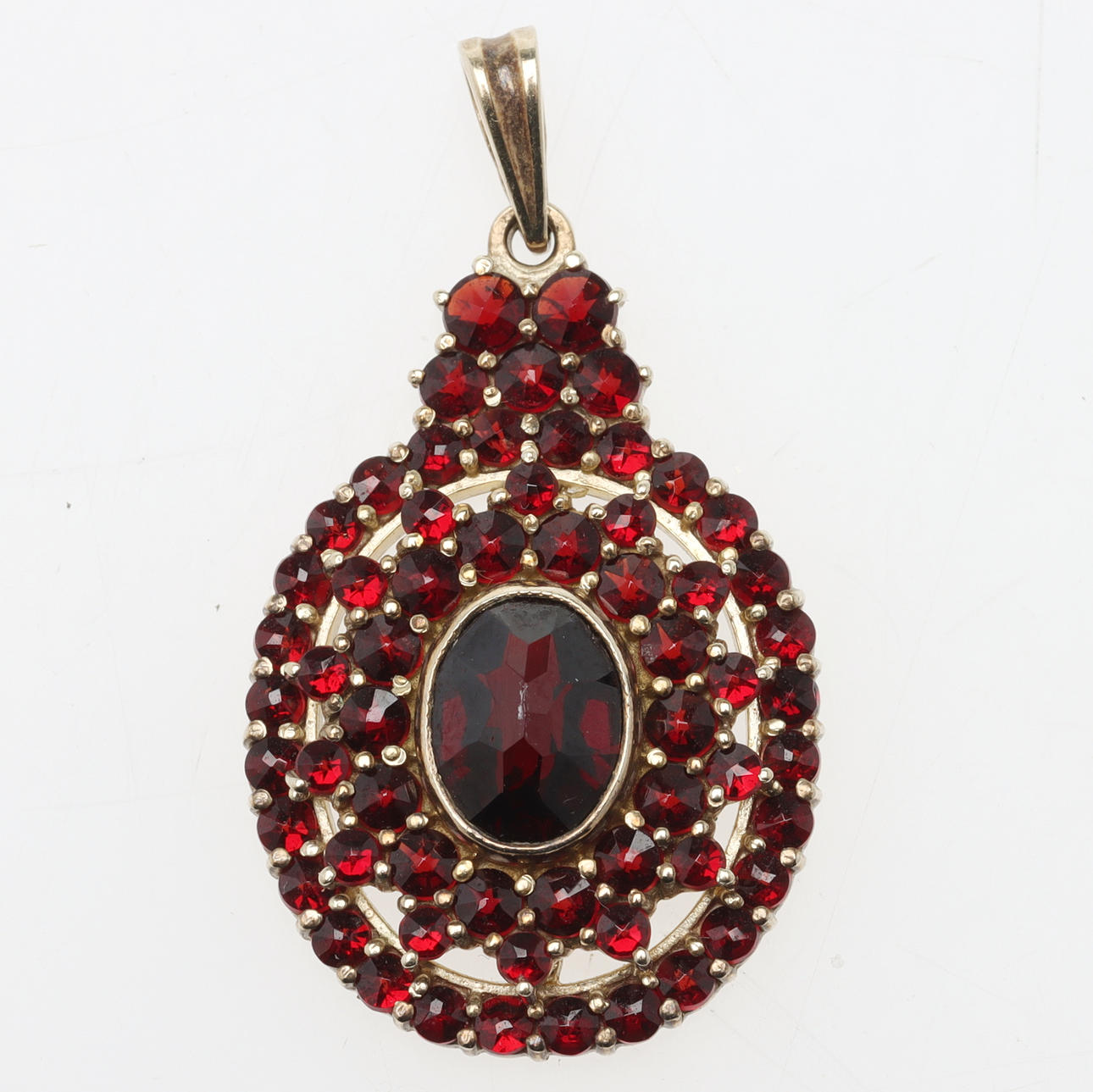 PENDANT, gilt silver, garnets.