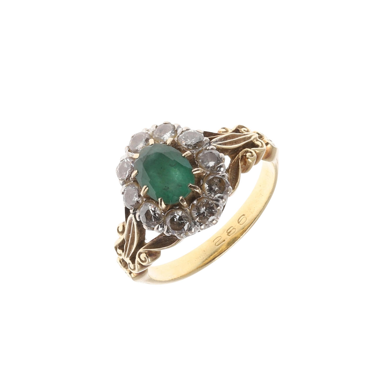 A GOLD, EMERALD AND DIAMOND CLUSTER RING.