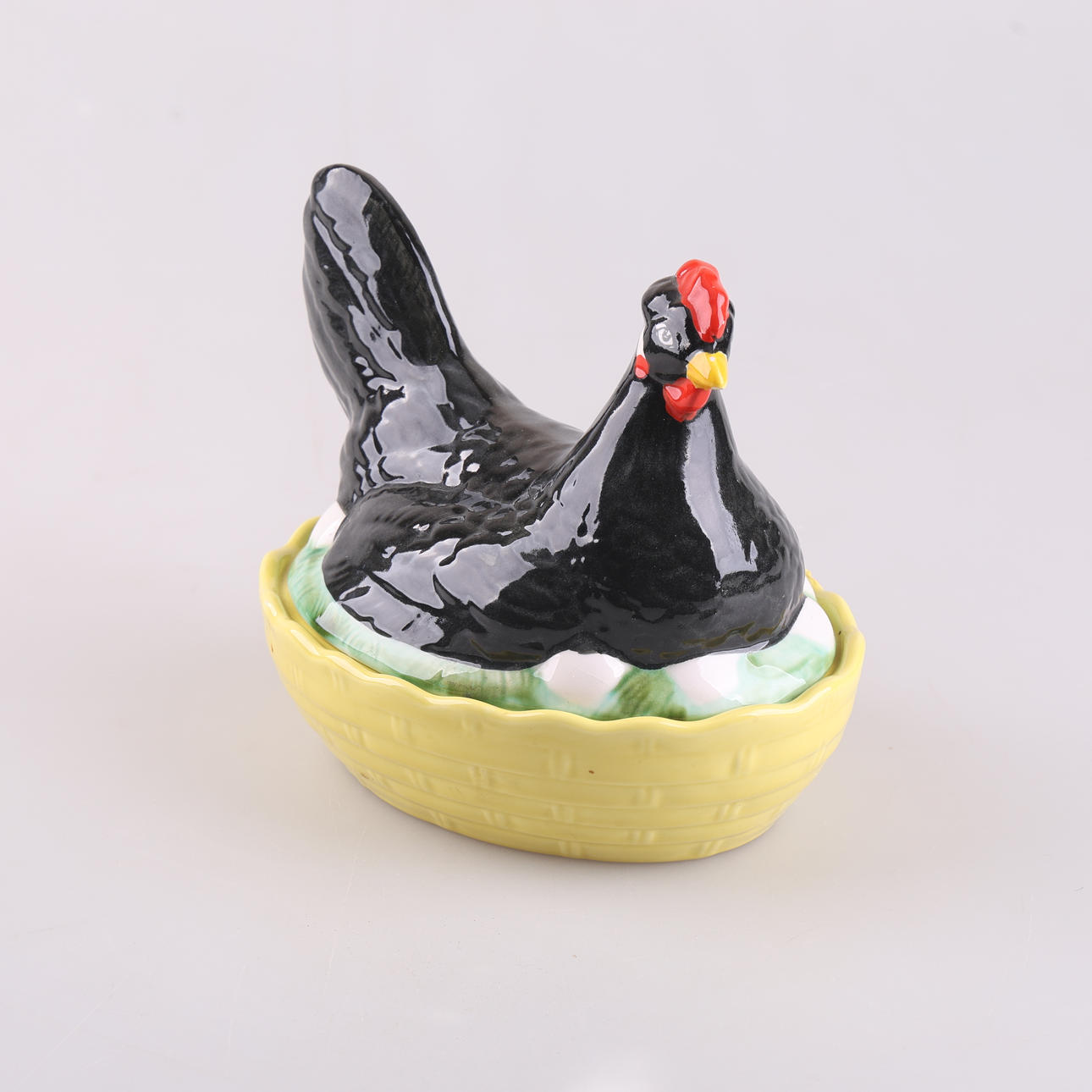 A mid 20th century porcelain egg hen.