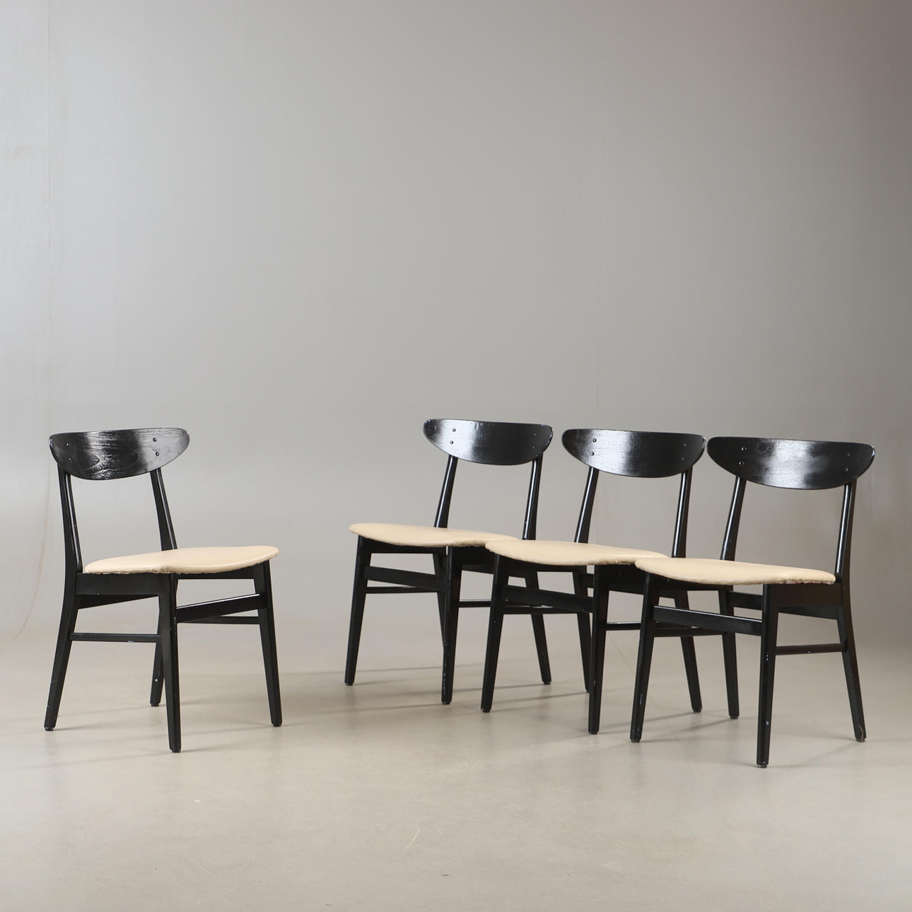 A set of four painted teak chairs from Farstrup, Denmark, mid 20th century.