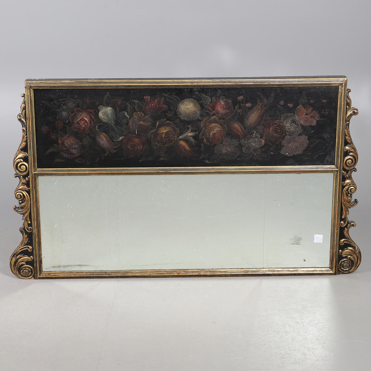 A GILT FRAMED LANDSCAPE OVERMANTEL MIRROR.