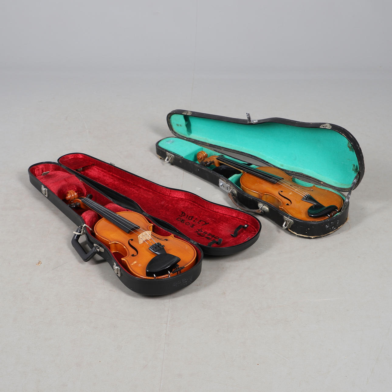 TWO CASED VIOLINS.