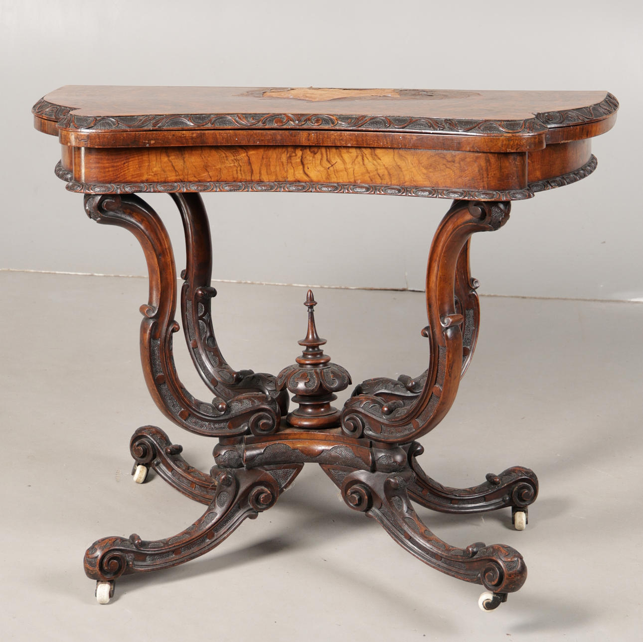 A 19TH CENTURY WALNUT CARVED CARD TABLE.