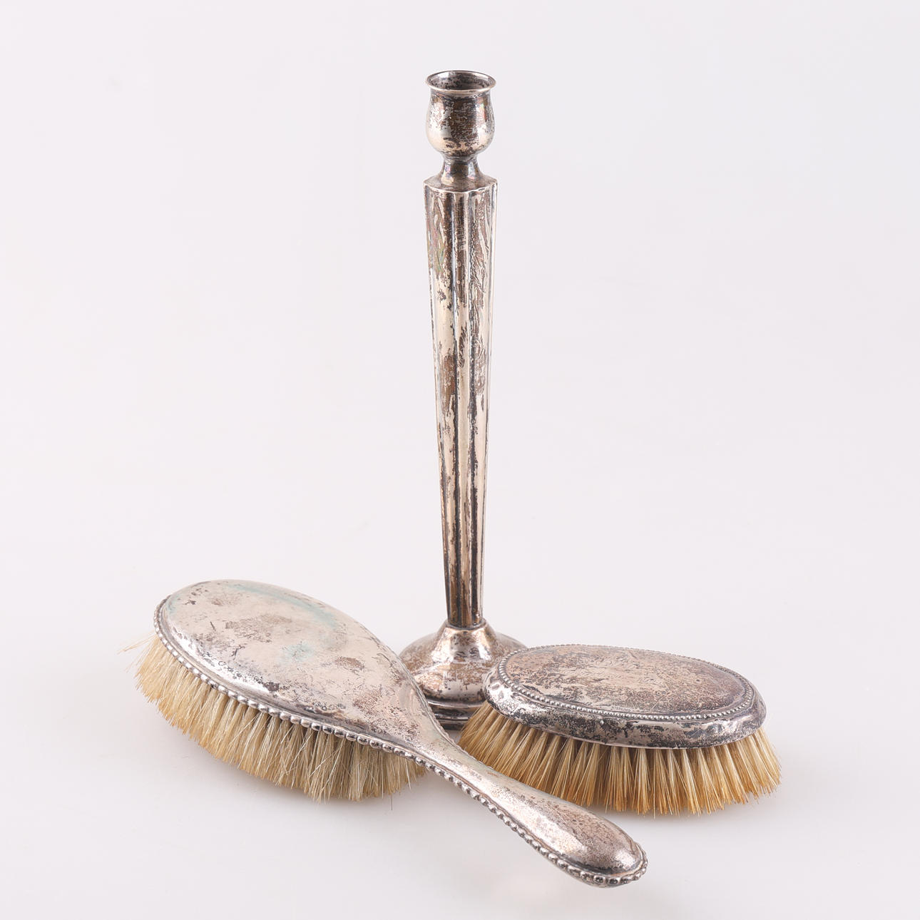 SILVER OBJECTS, 3 pieces, silver, candlestick and brushes.